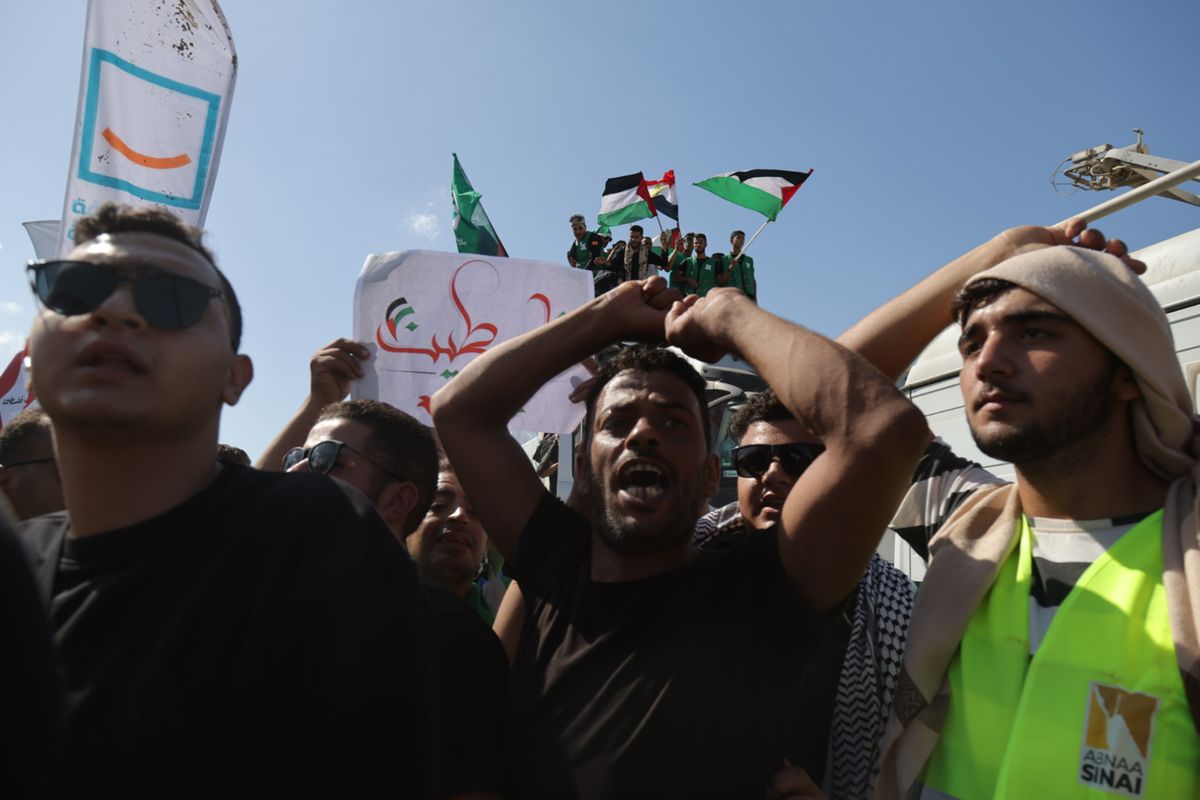 Demonstrators gather while U.N. Secretary General António Guterres visits the Rafah crossing between Egypt and the Gaza Strip on Friday.  (Sima Diab/For The Washington Post)