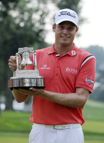 Nick Watney holds the trophy after winning the AT&T National. (Associated Press)