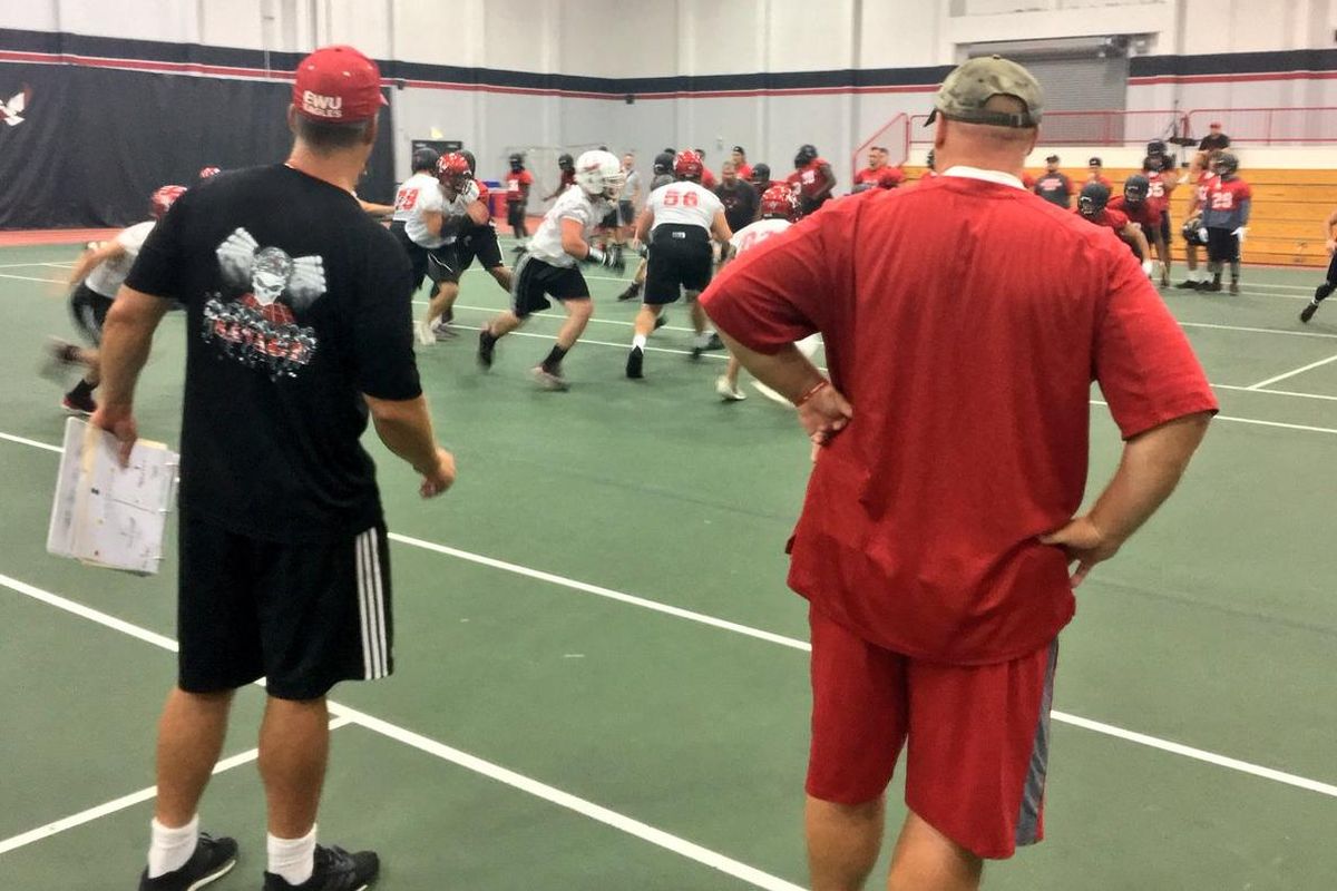 Eastern Washington coaches oversee practice moved indoors due to poor air quality across the region. (Jim Allen / The Spokesman-Review)