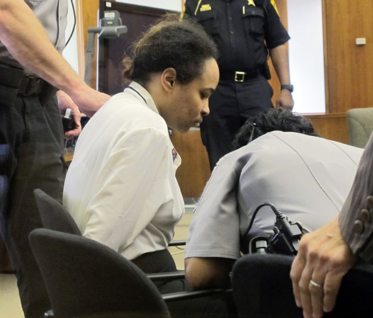 Annette Morales-Rodriguez waits for a deputy to release her leg chains in a Milwaukee court for the start of her trial on Monday, Sept. 17, 2012. She
