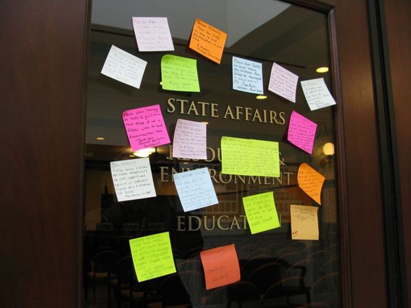 Sticky notes to Senate State Affairs Chairman Curt McKenzie, R-Nampa, left on the committee room door, urge him to hold a hearing on SB 1033, the bill to expand Idaho's anti-discrimination law to include sexual orientation; McKenzie has refused to hold a hearing on the bill, which was introduced in January. (Betsy Russell)
