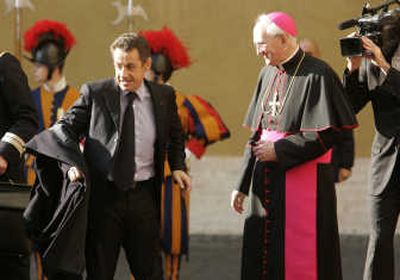 
French President Nicolas Sarkozy is greeted by Monsignor James Harvey at the Vatican Thursday. Associated Press
 (Associated Press / The Spokesman-Review)