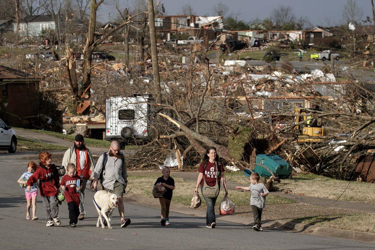 A family evacuates their Walnut Ridge neighborhood on Friday in Little Rock, Arkansas, after tornados damaged hundreds of homes and buildings across a large part of central Arkansas. (Benjamin Krain/Getty Images North America/TNS)