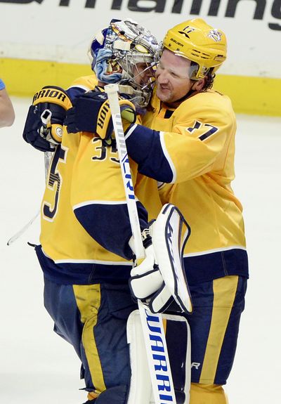 Nashville Predators goaltender Pekka Rinne (35), of Finland, celebrates with left wing Scott Hartnell (17) after the Predators defeated the Minnesota Wild in a shootout in an NHL hockey game Tuesday, March 27, 2018, in Nashville, Tenn. The Predators won 2-1. (Mark Zaleski / Associated Press)