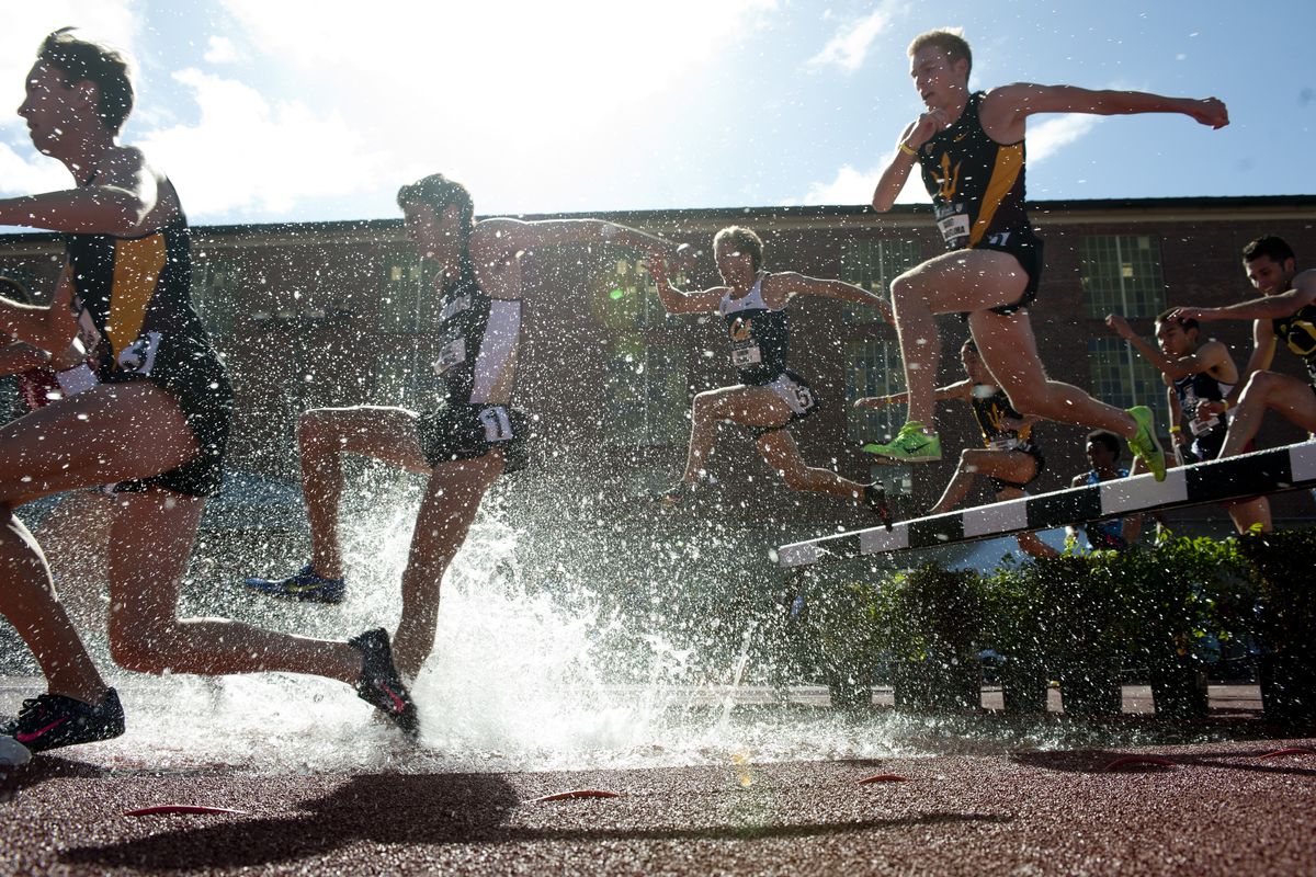 Runners make a splash in the men’s 3000-meter steeplechase during the 2014 Pac-12 Track and Field Championships in Pullman. (Tyler Tjomsland)