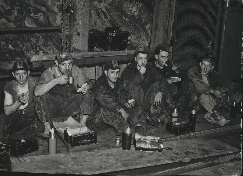 Miners take a break at the Bunker Hill & Sullivan Mill in Kellogg, Idaho, in 1938. A Canadian company says it wants to buy the long-closed mine in Kellogg with an eye toward restarting production there. Bunker Hill opened in 1885 and closed in 1981. (Spokesman-Review photo archive)