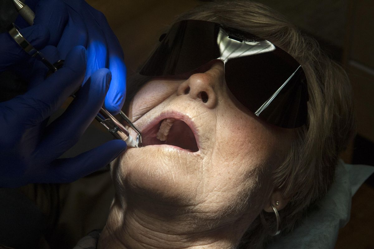 Joyce McNamee, 75, receives a shot before having a crown removed by Dr. Richard “Matt” Yarbro on July 27, 2016. Dental care costs for retired seniors are not covered by Medicare. (Dan Pelle / The Spokesman-Review)