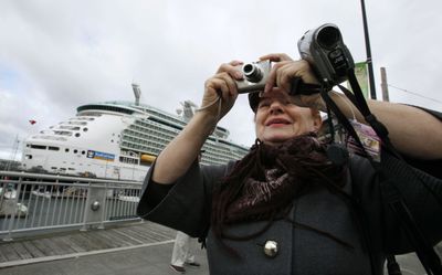 Adelaida Khopshanosova, of Los Angeles, walks  past her cruise ship shortly after it docked Thursday in Seattle.  (Associated Press / The Spokesman-Review)