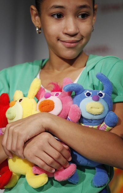 In this Sept. 28 photo, a girl shows off Sing-A-Ma-Jigs, named part of Time To Play's Holiday 2010 Most Wanted List, in New York. The plush doll from Mattel will retail for $12.99. The Christmas shopping season doesn't kick off for another six weeks, but retailers already are signaling they're prepared to discount aggressively if needed to entice shoppers still skittish about spending. (Mark Lennihan / Associated Press)