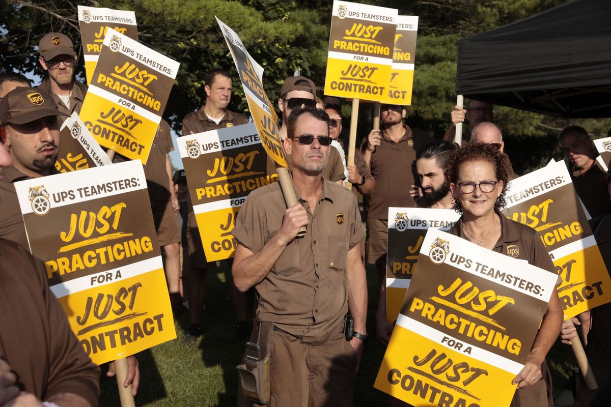 UPS workers and Teamsters members picket July 18 outside a UPS distribution facility in Madison Heights, Mich.  (Jeff Kowalsky/Bloomberg)