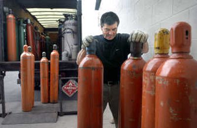 
Oxarc route manager Dan Griffith changes tanks of compressed helium at Wendle Motors on Monday. Local businesses have been dealing with a worldwide helium shortage. 
 (Holly Pickett / The Spokesman-Review)