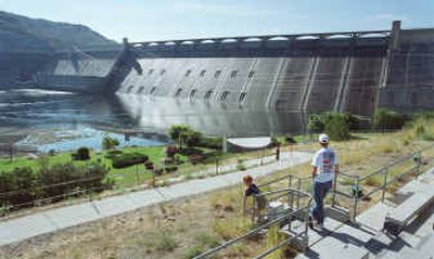 
Visitors to the Grand Coulee Dam are seen from the tourist center July 6, 2000. The dam in north-central Washington was built in the late 1930s as one of the largest concrete structures in the world. Tourists' visits have slowly climbed back since dropping 20 percent after the Sept. 11 terrorist attacks, although parts of the dam, which provides electricity to 11 Western states, are now off-limits and vehicles are no longer allowed to drive on it.
 (File/Associated Press / The Spokesman-Review)