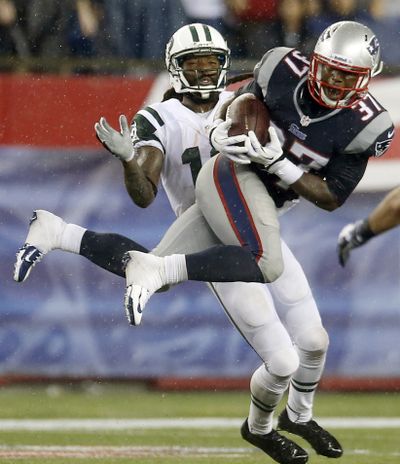 Patriots cornerback Alfonzo Dennard intercepts a pass intended for Jets wide receiver Clyde Gates. (Associated Press)