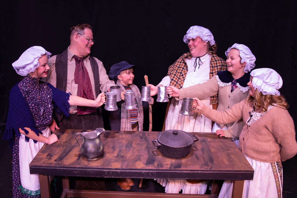 The Cratchit family gathers around a table at the Spokane Civic Theatre for the production of "Scrooge: The Musical."  (Courtesy)
