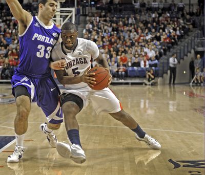 Gary Bell of Gonzaga looks for an opening as he drives to the basket past the defense of Nemanja Mitrovic of Portland during their game at The Kennel Wednesday Dec. 28, 2011. (Christopher Anderson / Spokesman-Review)