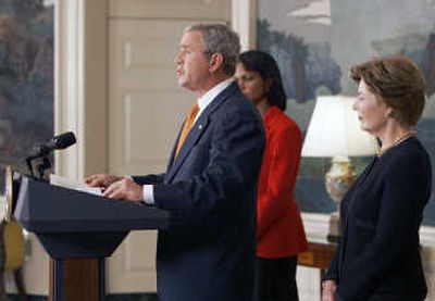
President Bush, accompanied by Secretary of State Condoleezza Rice and first lady Laura Bush, makes a statement on Burma Sanctions on Friday at the White House. Associated Press
 (Associated Press / The Spokesman-Review)