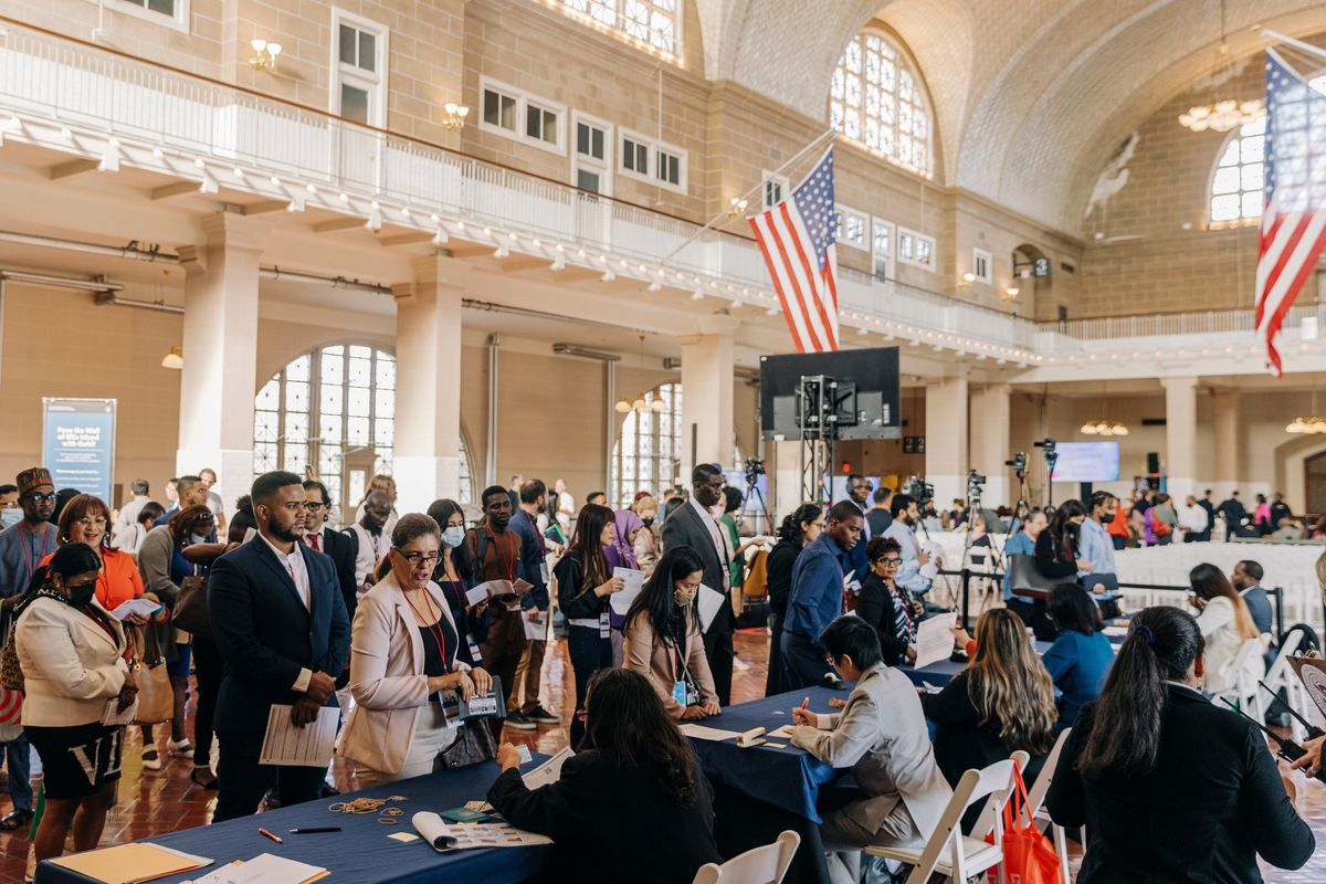 People wait to attend a naturalization ceremony at Ellis Island in New York on Saturday, Sept. 17, 2022. An emotional Attorney General Merrick Garland addressed new citizens on Saturday at Ellis Island, the site of his family