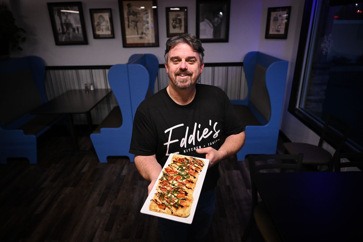 Kevin Pereira poses for a photo with one of Eddie’s Kitchen and Tavern’s flatbreads on Dec. 11 at Eddie’s Kitchen and Tavern in north Spokane. Pereira is the former co-owner of Lost Boys Garage and Summit Kitchen.  (Tyler Tjomsland/The Spokesman-Review)