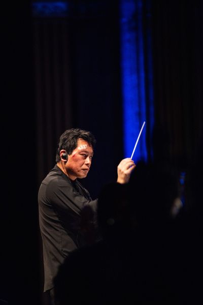 Morihiko Nakahara conducts the Spokane Symphony on Saturday during a performance of “Star Wars: The Empire Strikes Back” after an accident sent him to the emergency room that afternoon. (Courtesy of Danny Cordero)