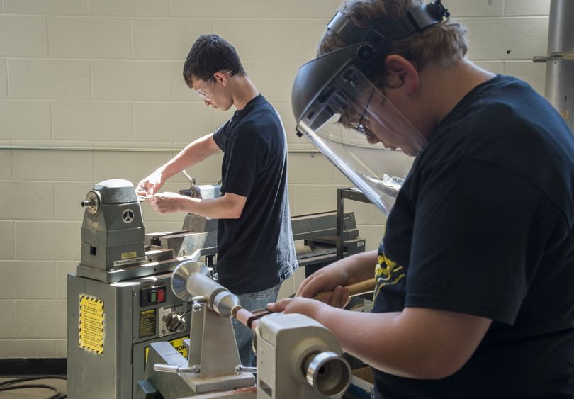 East Valley Middle School eighth-graders Austin Prochnow, 14, left, and Anthony Huck, 14, use lathes to chisel and sand tulipwood into parts to make fountain pens on May 7. Students have been making the wooden pens to give to veterans who plan to take the Honor Flight. Above, one of the pens. (Colin Mulvany)