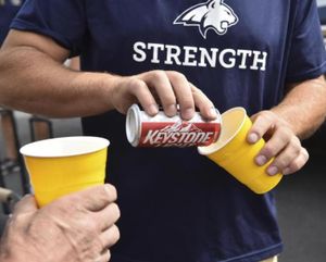 A Montana State fan pours a beer for a friend before the start of a college football game against Idaho on Thursday, Sep 1, 2016, outside the Kibbie Dome in Moscow. (Tyler Tjomsland/SR photo)