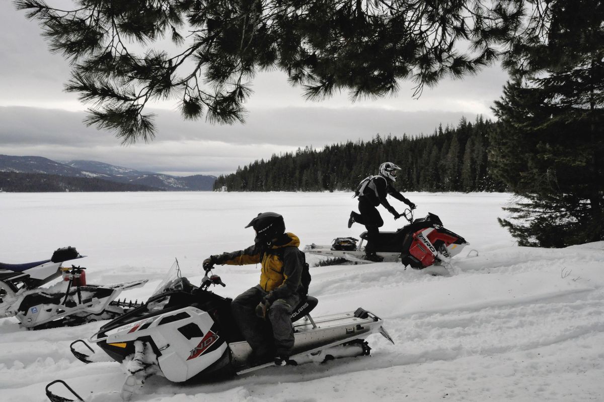 Ryan Porter, right, joins Merlin Walraven for a snowmobiling break on the shore of Priest Lake near Beaver Creek Campground. (Rich Landers / The Spokesman-Review)