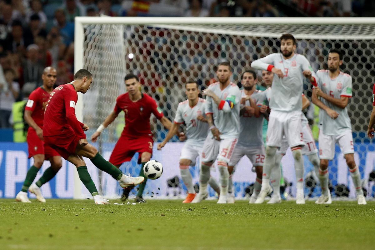 Portugal’s Cristiano Ronaldo, left, scores his side’s equalizing goal during the group B match between Portugal and Spain at the 2018 soccer World Cup in the Fisht Stadium in Sochi, Russia, Friday, June 15, 2018. (Francisco Seco / Associated Press)