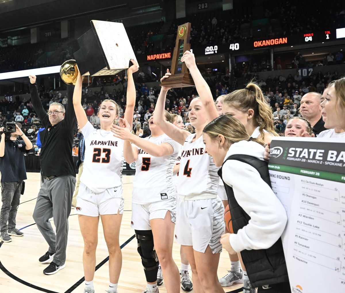 Napavine’s Keira O’Neill (23) hoists the State 2B trophy Saturday after the Tigers beat Okanogan 41-40.  (Jesse Tinsley/THE SPOKESMAN-REVIEW)