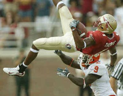 
Florida State receiver Craphonso Thorpe is up-ended by Clemson's Justin Miller during second-quarter action on Saturday. 
 (Associated Press / The Spokesman-Review)
