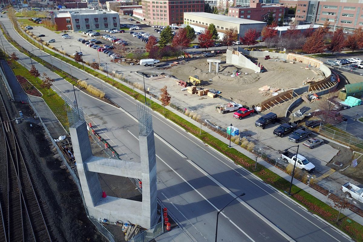 The support arch, shown Tuesday at right, for the new University District pedestrian and bicycle bridge rises more than 40 feet into the air. Construction has stopped until the new year.  The south side ramp structure is  at left. (Jesse Tinsley / The Spokesman-Review)