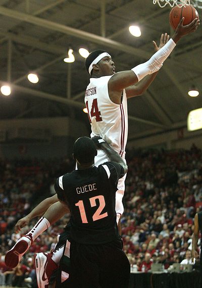 WSU’s James Watson goes to the rim against Paul Guede of Portland State.  (Associated Press)