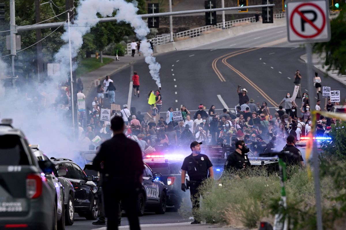 Smoke begins to drop into a crowd of several hundred who arrived from the "ICE OUT" protest held in Riverfront Park and joined the anti-ICE protest around the old Broadview Dairy on the north side of Riverfront Park Wednesday, June 11, 2025. The earlier protesters were attempting to prevent people arrested by the Immigration and Customs Enforcement agency from being put in a van and sending them to the detention center in Tacoma. After a large group of Spokane Police Department secured the area around the ICE office, the larger group showed up and were dispersed by smoke cannisters and pepper balls. (Jesse Tinsley/THE SPOKESMAN-REVIEW)
