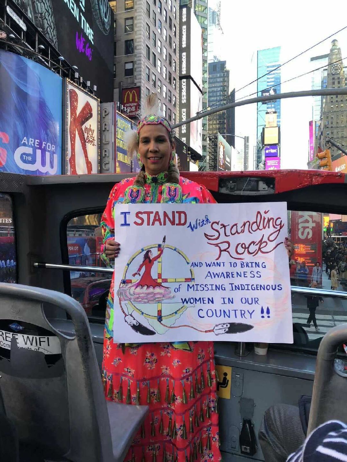 Ann Ford, a Coeur d’Alene tribal member, carried a sign raising awareness of the crisis of missing and murdered Indigenous women and wore a red handprint, the symbol of the movement against MMIW, to last year’s Indigenous Peoples March in Spokane. She also took her sign to Washington, D.C., and New York City’s Times Square.  (Courtesy of Ann Ford)