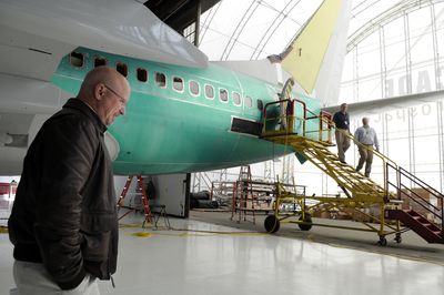 Bret Burnside, president of Cascade Aerospace USA, walks around a Boeing business jet being fitted with an executive interior at Cascade’s facility at Spokane International Airport on Thursday. The company, which provides maintenance on commercial and private aircraft, held its official opening Thursday.  (Jesse Tinsley / The Spokesman-Review)