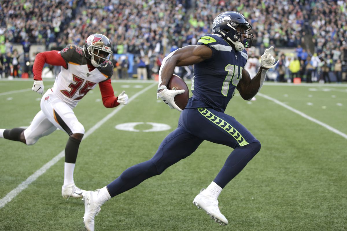 FILE – Seattle Seahawks wide receiver DK Metcalf, right, runs to score a touchdown ahead of Tampa Bay Buccaneers defensive back Jamel Dean during the second half of an NFL football game, Sunday, Nov. 3, 2019, in Seattle. Metcalf didn’t disappoint in his rookie season even after sliding in the draft. It’s raised the expectations for what many are expecting to be a breakout season for Seattle’s second-year wide receiver.  (Scott Eklund)