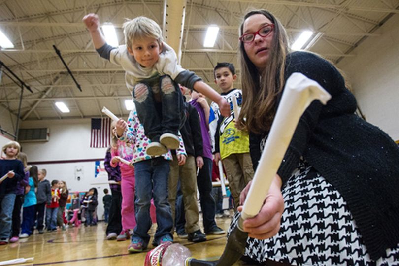 Reese Kinnerson, 6, takes one giant leap, launching an air-powered, paper rocket to the ���moon��� at Fernan Elementary Wednesday when Shelley Best, right, with the Discovery Center of Idaho taught students about overcoming the challenges of space travel. (Gabe Green/press)
