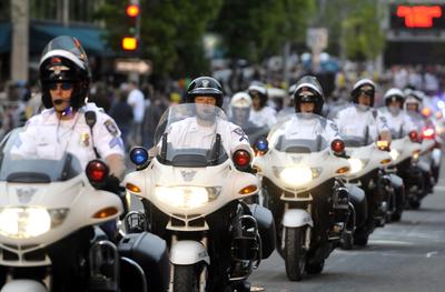 Motorcycle units from multiple police agencies lead off the 2009 Armed Forces Torchlight Parade Saturday. (Photos by Jesse Tinsley / The Spokesman-Review)