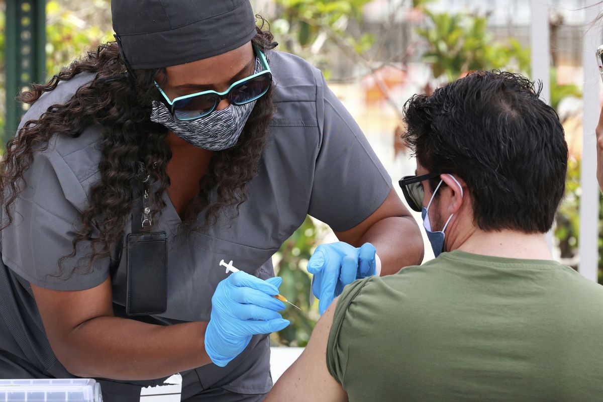 An Orange County resident receives the COVID-19 vaccine June 17 at the Florida Division of Emergency Management mobile vaccination site at Camping World Stadium in Orlando, Fla.  (Joe Burbank)