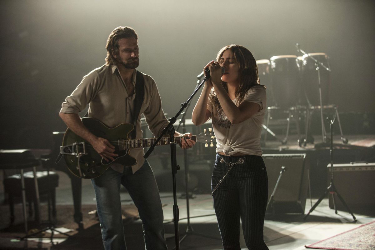 This image released by Warner Bros. shows Bradley Cooper, left, and Lady Gaga in a scene from the latest reboot of the film, “A Star is Born.” Barbra Streisand is giving an early thumbs-up to the remake of A Star Is Born with Lady Gaga and Bradley Cooper. Streisand and Kris Kristofferson topped the 1976 version of the romantic drama about a rising performer and a fading star. (Neal Preston / AP)