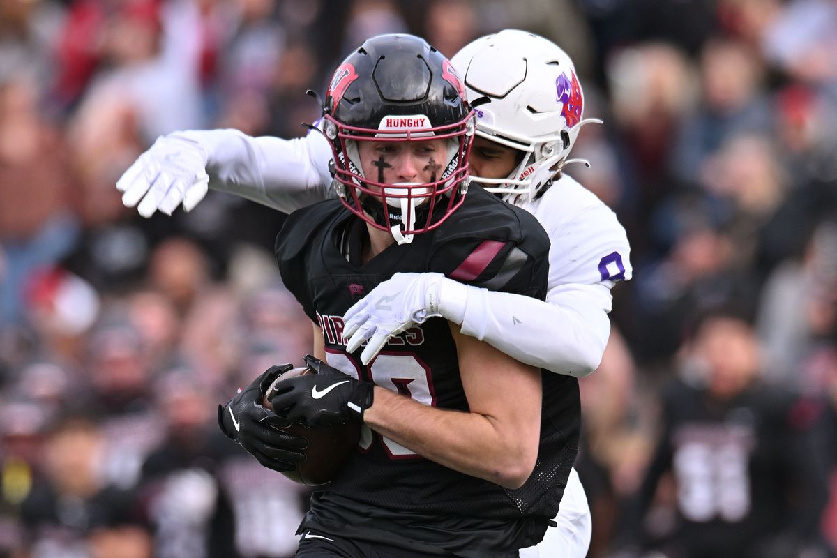 Whitworth’s Evan Liggett makes a recetion in front of Linfield cornerback Chance Sparks during the first half of Saturday’s Northwest Conference game at the Pine Bowl.  (James Snook)