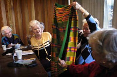 
Virginia Brown, Irene Carter, Doris Swanson and Louise Steegstra listen as Dee Alter, 84, shows a skirt that she made from hand-woven fabric when she was living in Ghana, after sharing some of her memories with the senior writers group at Rockwood Manor. Alter, who is legally blind, recorded her stories with a tape recorder, then played the tape at the meeting. 
 (Holly Pickett / The Spokesman-Review)