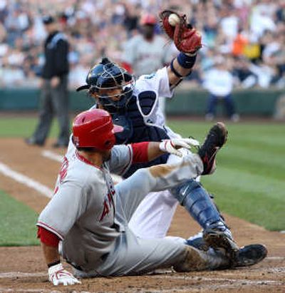 Seattle catcher Kenji Johjima tags out Angels' Casey Kotchman after taking a throw from Ichiro Suzuki in the second inning.Associated Press
 (Associated Press / The Spokesman-Review)