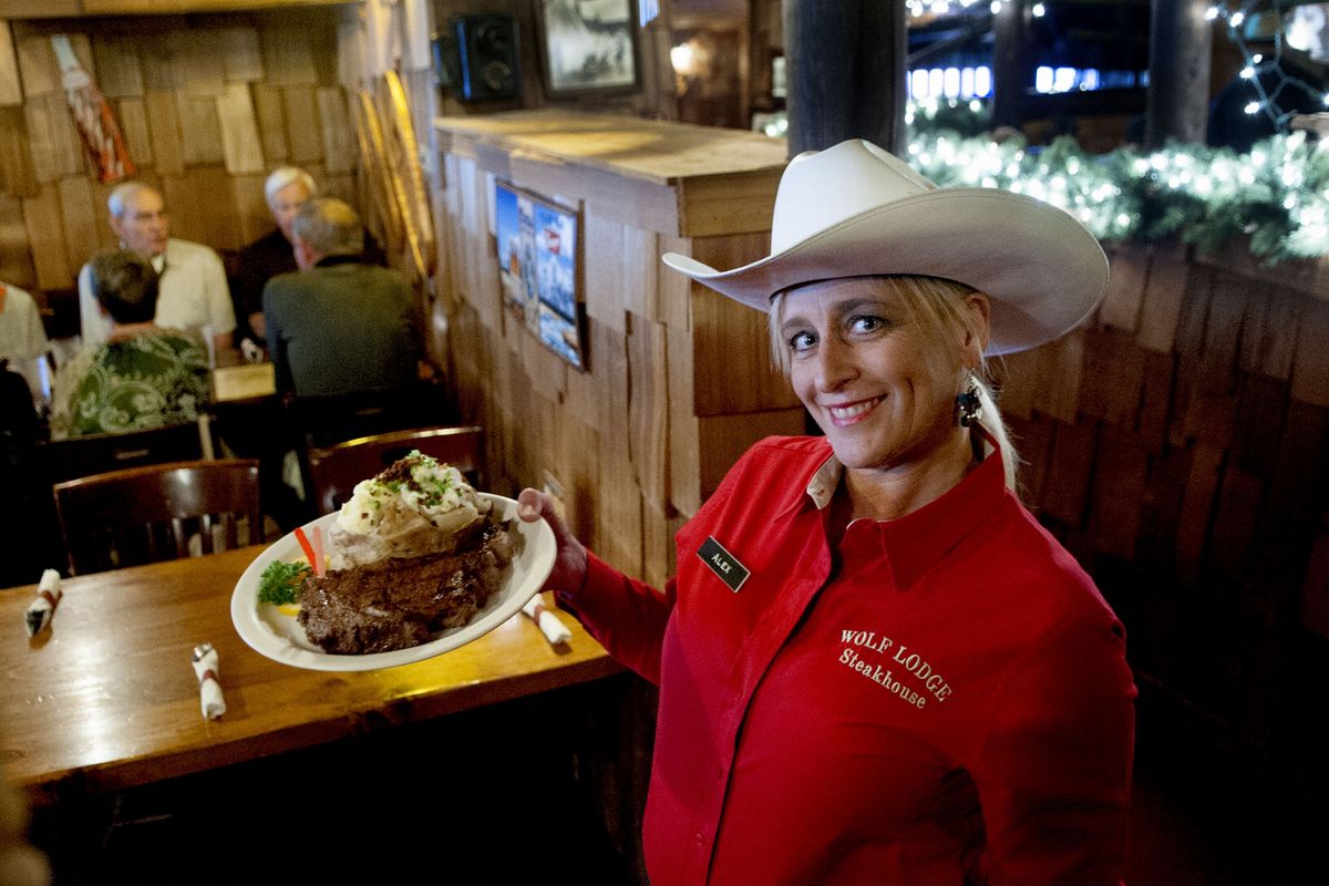 Wolf Lodge server Alex McNett shows off the 16-ounce ribeye.