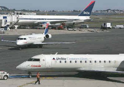 
Delta and Delta Connection jet aircraft appear on the tarmac near the terminal at Boston's Logan International Airport. 
 (Associated Press / The Spokesman-Review)
