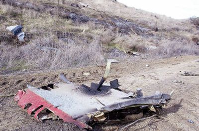 
Pieces of a Navy jet litter a hillside west of Helix, Ore., after the jet crashed Friday during a  training mission. 
 (Associated Press / The Spokesman-Review)