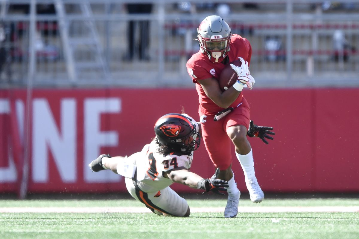 Washington State Cougars wide receiver Calvin Jackson Jr. (8) runs the ball against Oregon State Beavers linebacker Avery Roberts (34) during the first half of college football game on Saturday,Oct 9, 2021, at Martin Stadium in Pullman, Wash.  (Tyler Tjomsland/The Spokesman-Review)