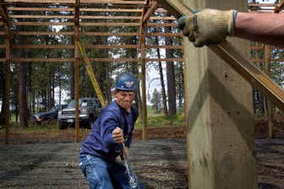 
Rob McGarvey, working for Baker Construction and Development, tightens a racking cable used to square the new 6,000-square-foot covered play area at Liberty School in Spangle on Tuesday. The covered play area will allow students to go outdoors for recess during bad weather. 
 (Jed Conklin / The Spokesman-Review)