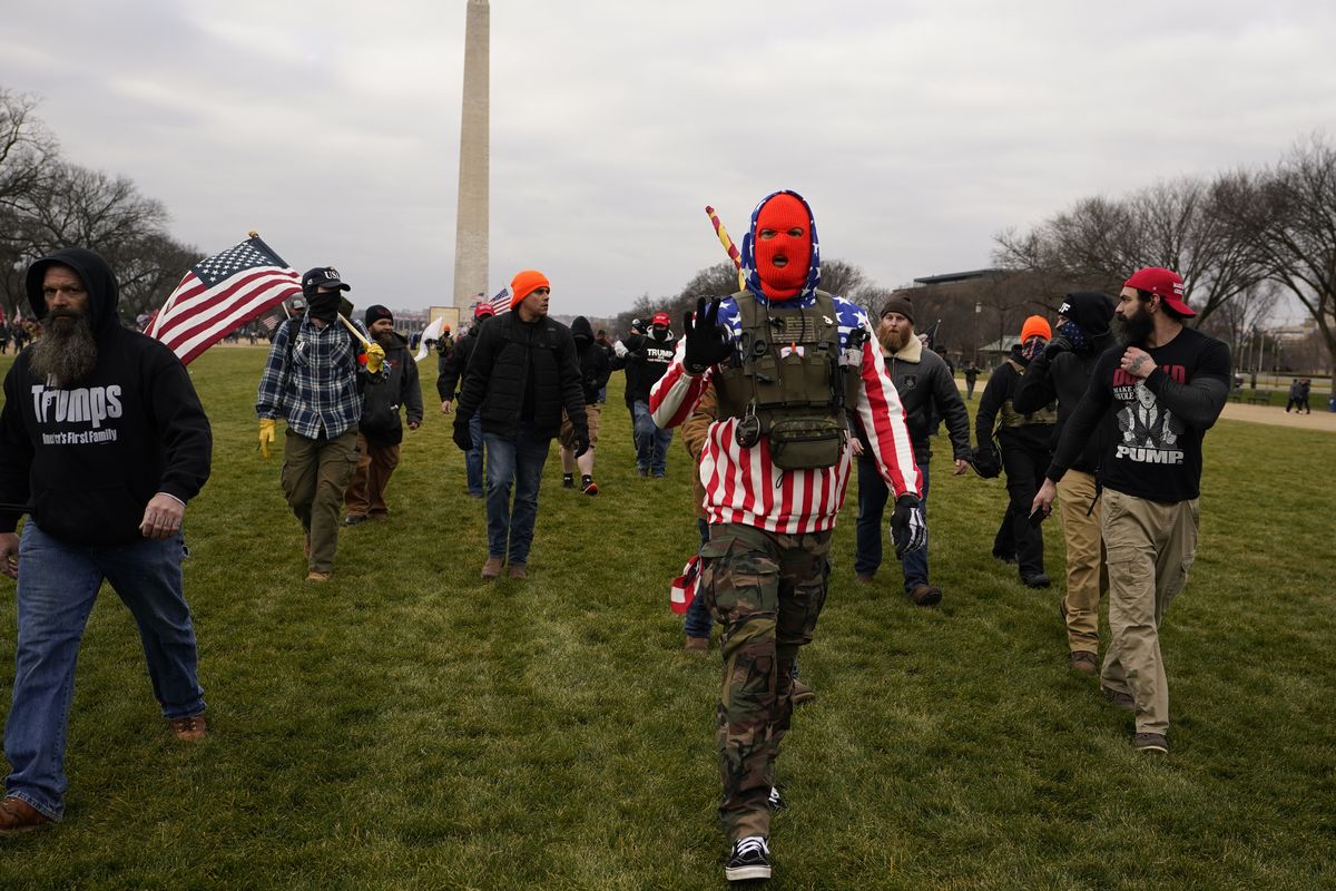 FILE - In this Jan. 6, 2021, file photo, people march with those who say they are members of the Proud Boys as they attend a rally in Washington in support of President Donald Trump. In its annual report set to be released Monday, Feb. 1, 2021, the Southern Poverty Law Center said it identified 838 active hate groups operating across the U.S. in 2020. The SPLC’s report comes out nearly a month after a mostly white mob of Trump supporters and members of far-right groups violently breached the U.S. Capitol building.  (Carolyn Kaster)