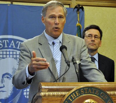 Gov. Jay Inslee discusses the change in federal policy toward marijuana enforcement while state Attorney General Bob Ferguson looks on. (Jim Camden)