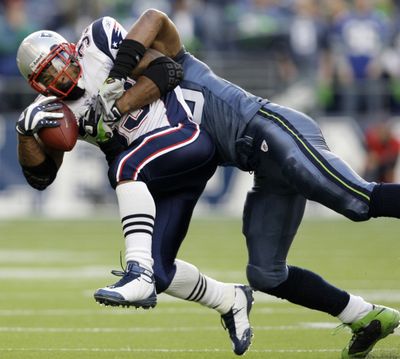 Julian Peterson of the Seahawks tackles New England’s Kevin Faulk on a pass play in the first half of Sunday’s game at Qwest Field.  (Associated Press / The Spokesman-Review)